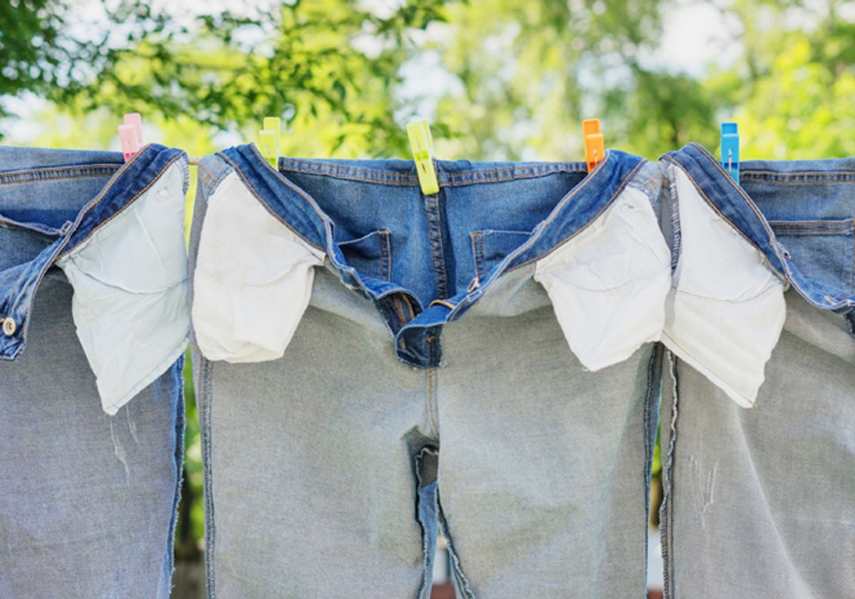 Picture of three pairs of jeans that are inside out and hung on a clothesline.
