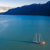 A boat, the Tara, sailing past an island in Patagonia, Chile