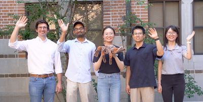 A group of researchers from Rice University pose with a toy spider to celebrate their 2023 Ig Nobel Prize.