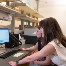 Professor Alexandra Whiteley and graduate student Autumn Matthews look at an image of a western blot on their laboratory computer.
