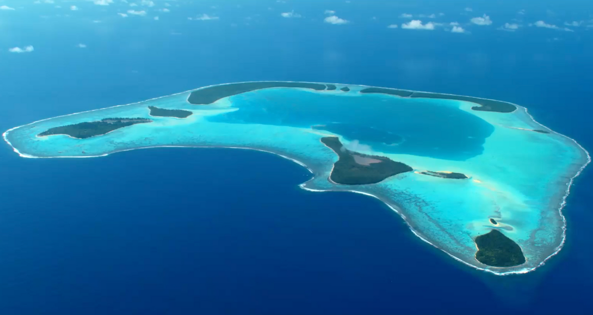 Aerial view of an atoll and the surrounding water