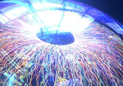 A close-up of the human eye, showing a colorful iris, black pupil, and transparent cornea.