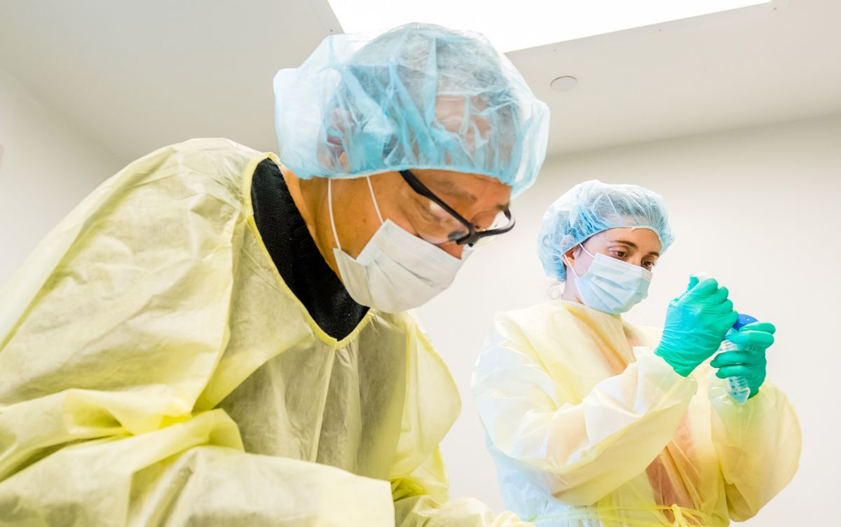 Photograph of scientists working while wearing PPE